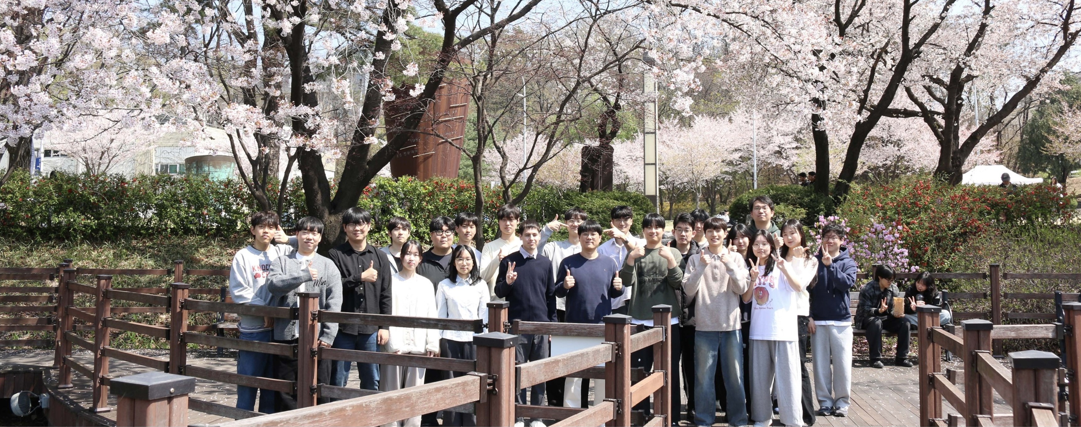 The full AD-Lab group gathered on campus during cherry blossom season